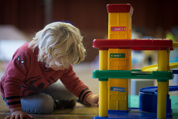 A young boy plays with toys at a playgroup for pre-school aged children.