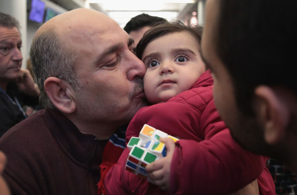 Syrian Refugee Family Arrives In U.S. As Immigration Ban Is Debated In Court