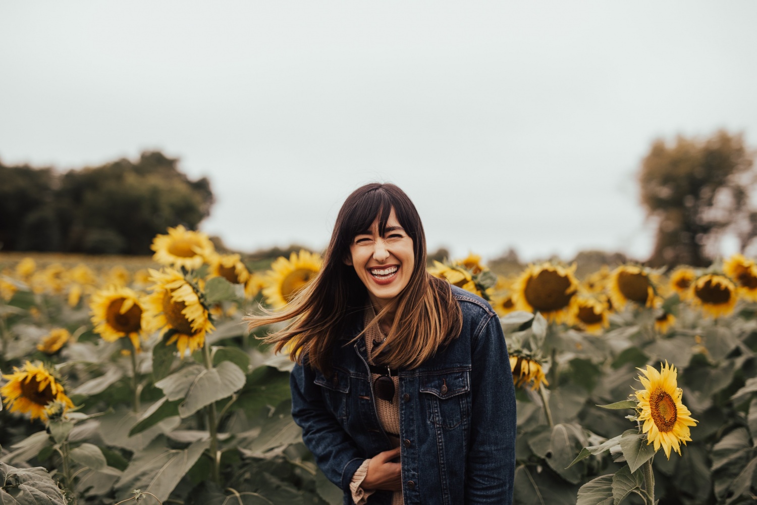 Girl smiling in sunflower field