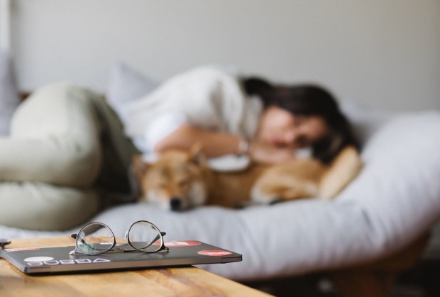 girl and dog asleep on the couch