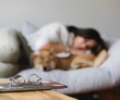 girl and dog asleep on the couch